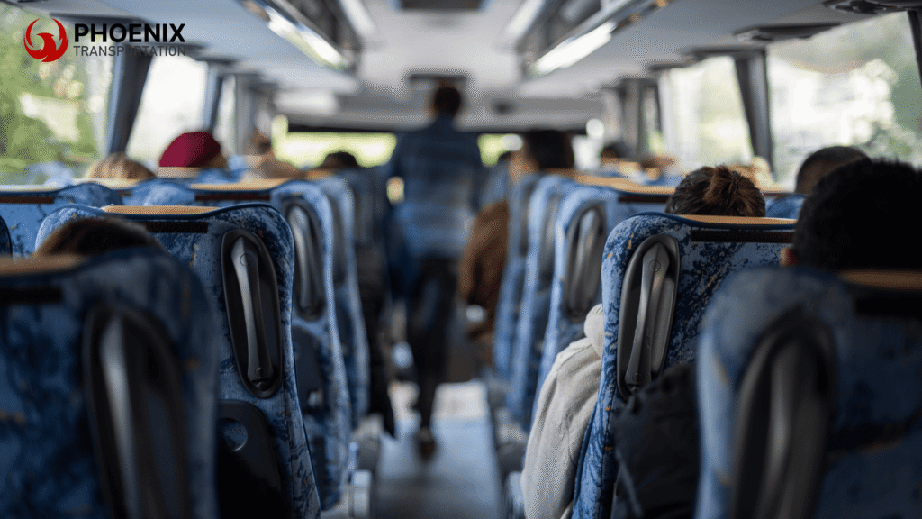 Interior Of A Bus With Blue Patterned Seats, Mostly Occupied. A Person Walks Down The Aisle, Going To San Jose Municipal Rose Garden