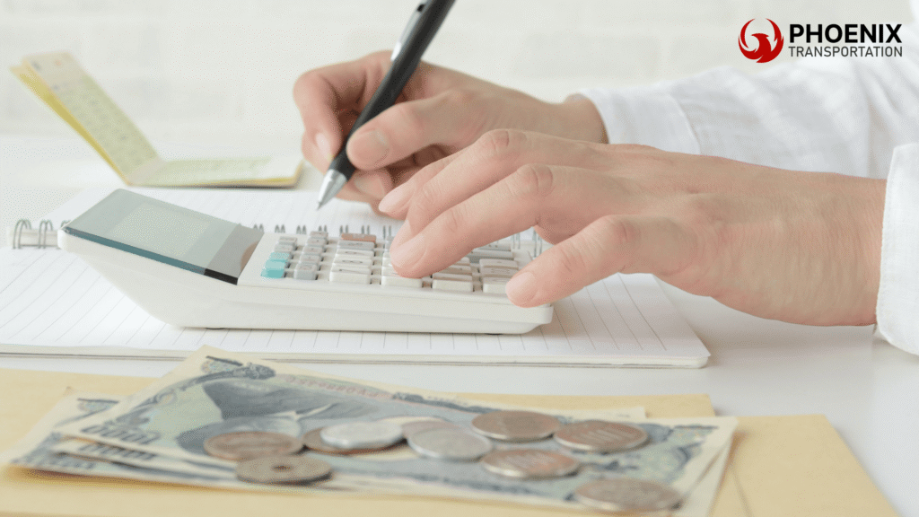 A person uses a calculator on a notepad with cash and coins, illustrating budgeting and financial planning.