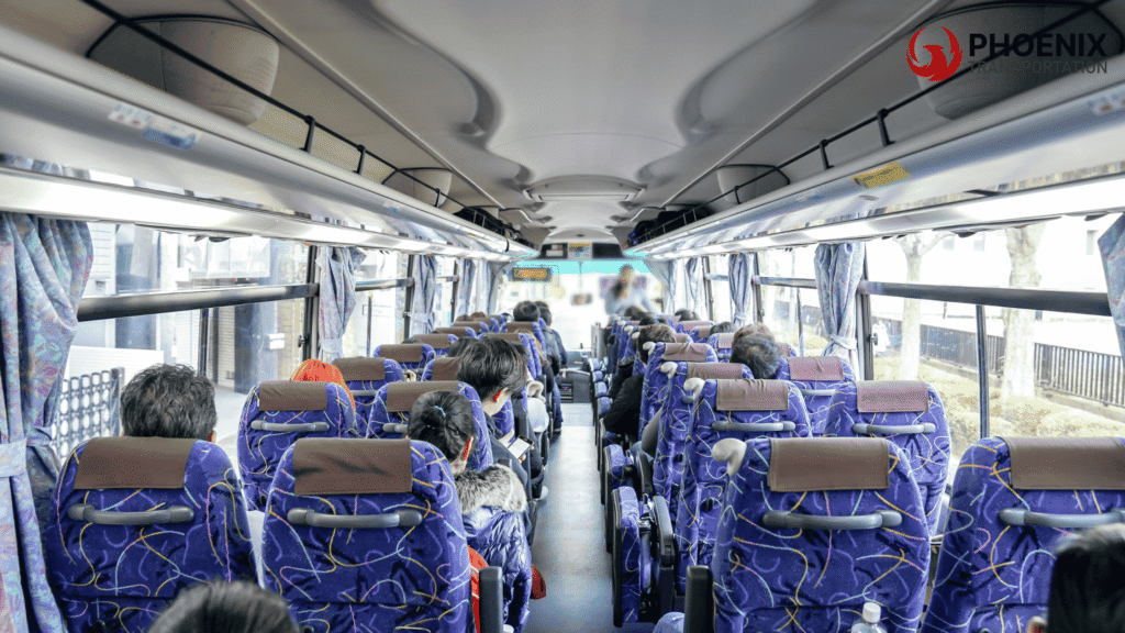 Interior of an oakland bus with passengers seated, blue and purple seats, sunlight through the windows, calm travel atmosphere.