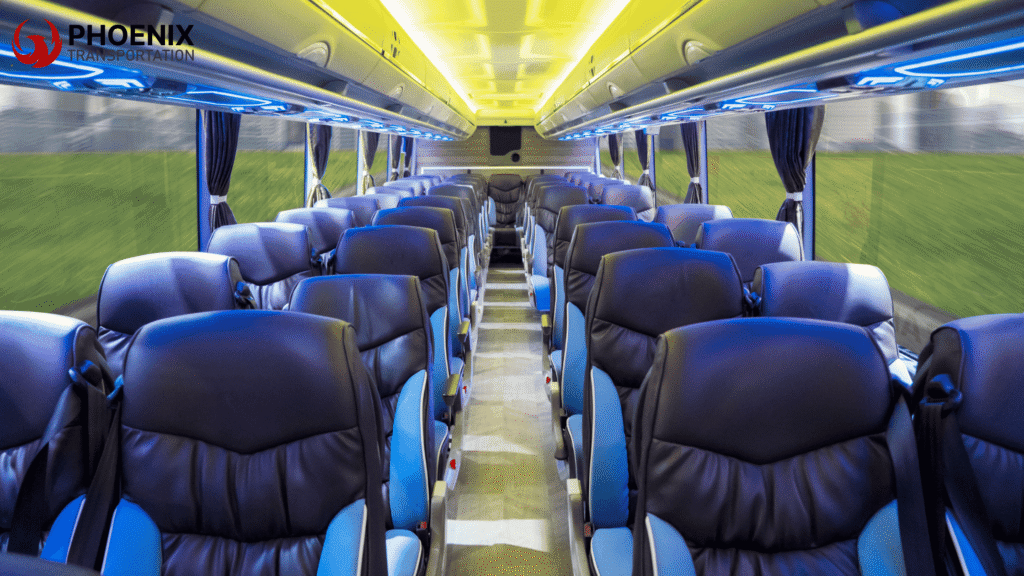 Luxury bus interior with blue and black seats, yellow overhead lights, and blue accents creating a modern, inviting atmosphere.